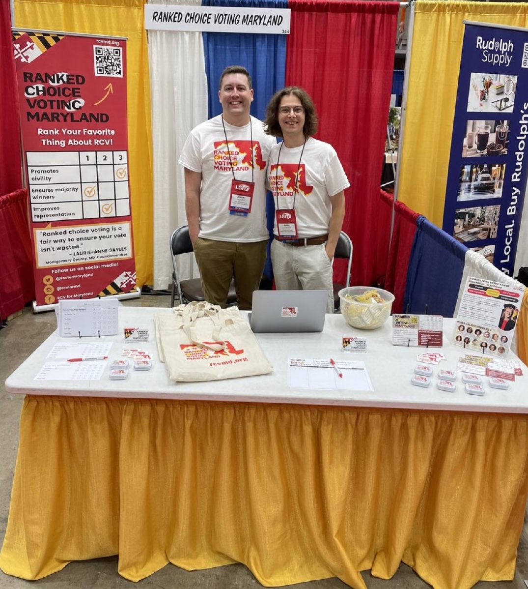 Jeremy Rose & Owen Anderson standing behind a table covered with RCVMD material.